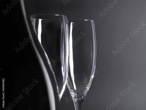 Champagne and two glasses, isolated on black