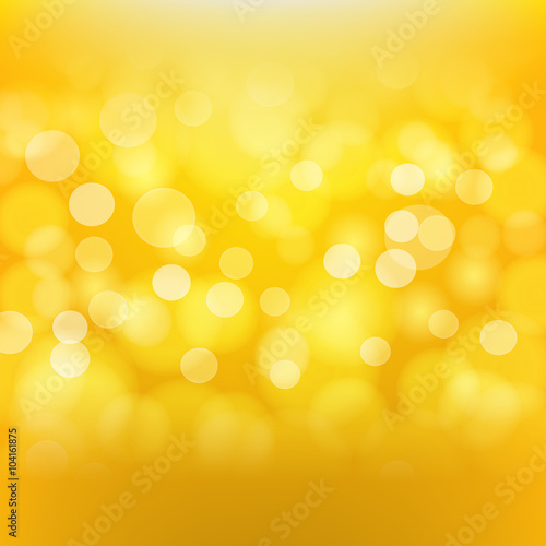 Golden background with blurred light effects. Vector