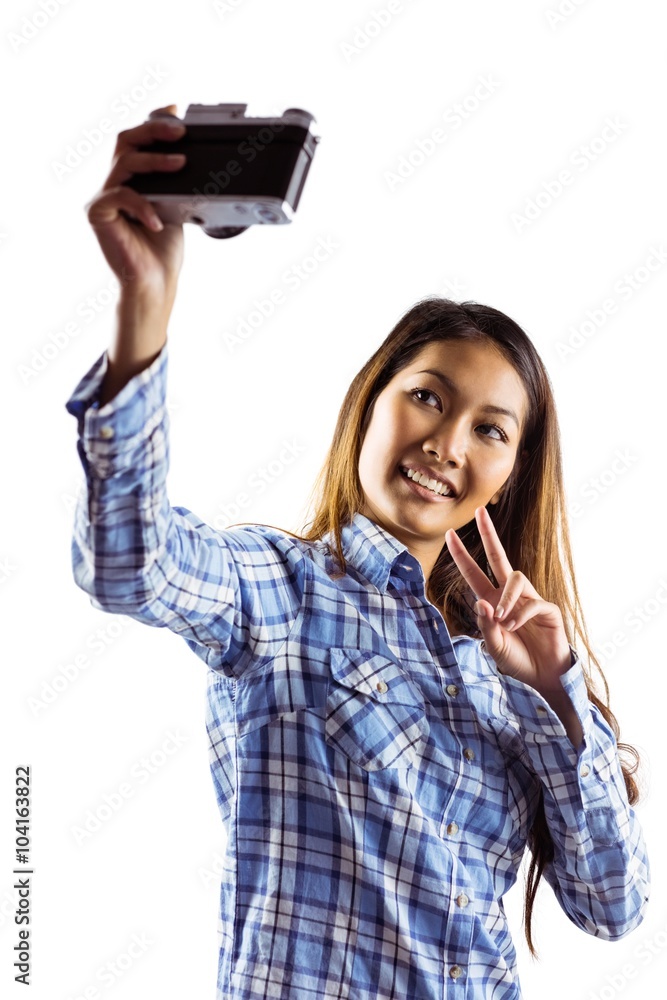 Smiling asian woman taking picture with camera Smiling asian woman taking picture with camera