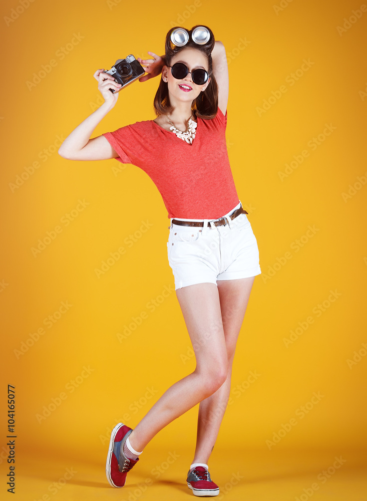 Young attractive fashionable surprised woman with old-school cam Young attractive fashionable surprised woman with old-school cam