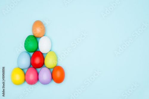 Colorful easter eggs on pastel background  Triangle Shape