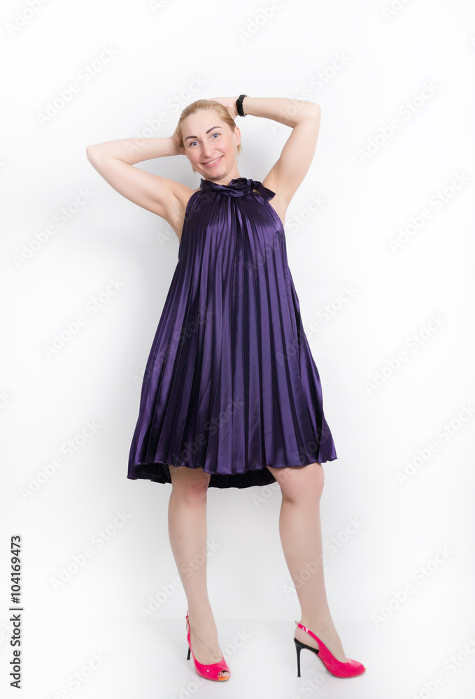 beautiful young leggy blond girl in a long purple dress on a red high heels, posing beautiful young leggy blond girl in a long purple dress on a red high heels, posing