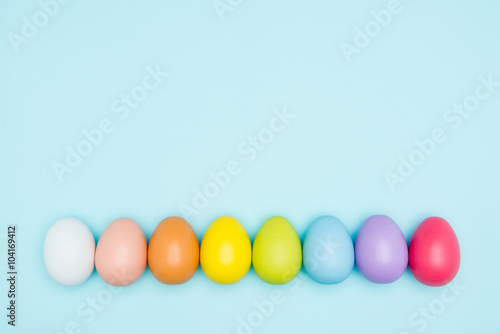 Colorful easter eggs on pastel background