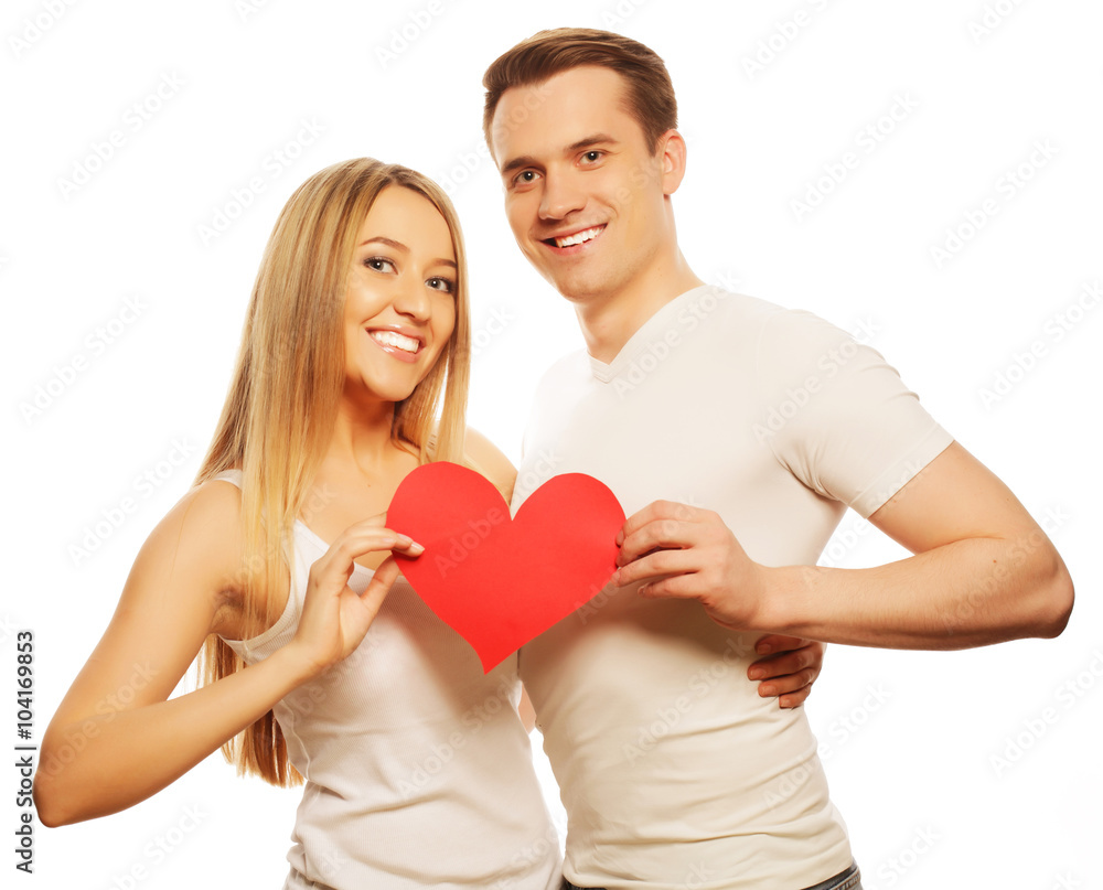 Happy couple in love holding red heart Happy couple in love holding red heart