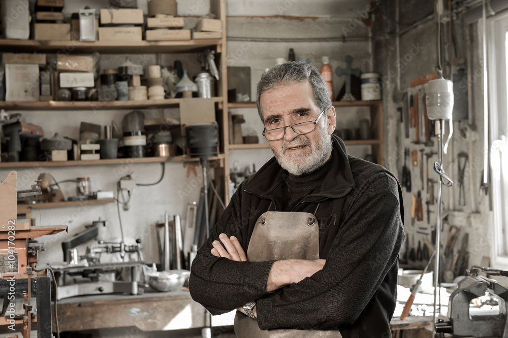 Portrait Master goldsmith working in his workshop Portrait Master goldsmith working in his workshop