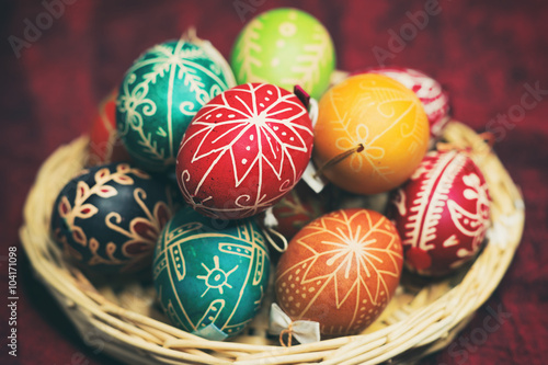Vintage style photo from decorated Easter eggs in a basket with traditional hungarian patterns