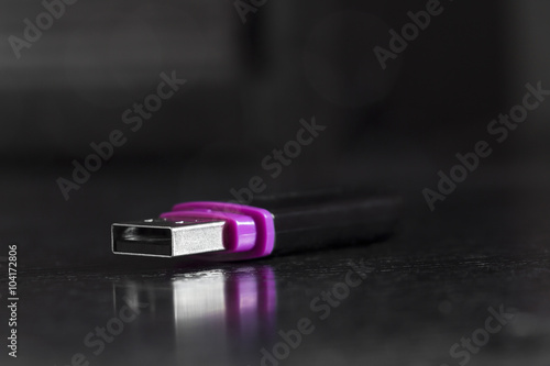 USB flash drive on a black office desk