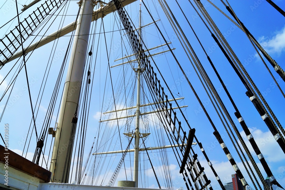 Mainmast of a sailing ship under blue sky Mainmast of a sailing ship under blue sky