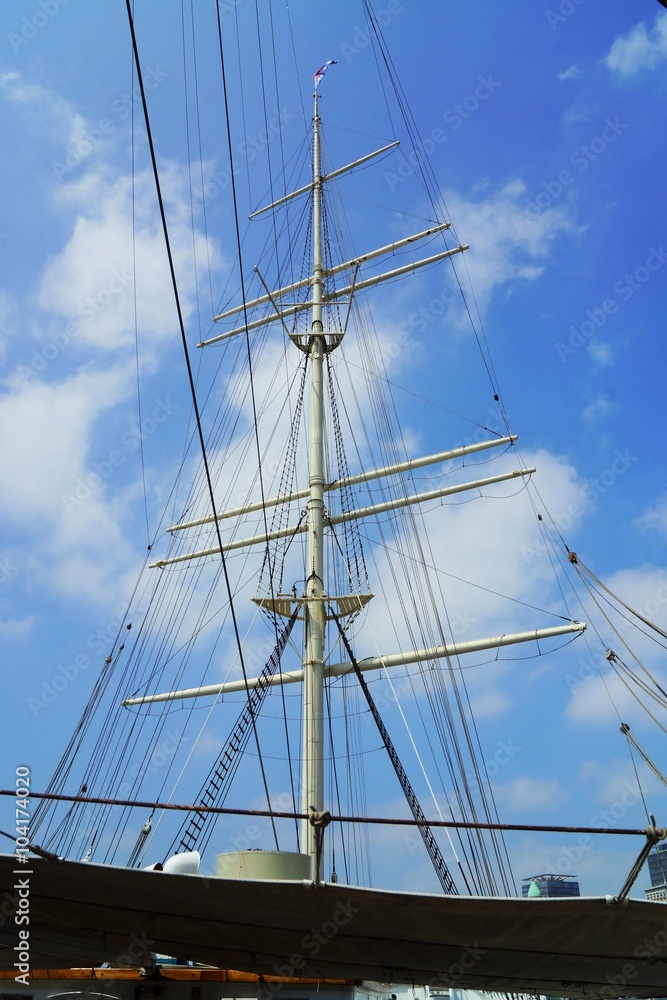 Mainmast of a sailing ship under blue sky Mainmast of a sailing ship under blue sky