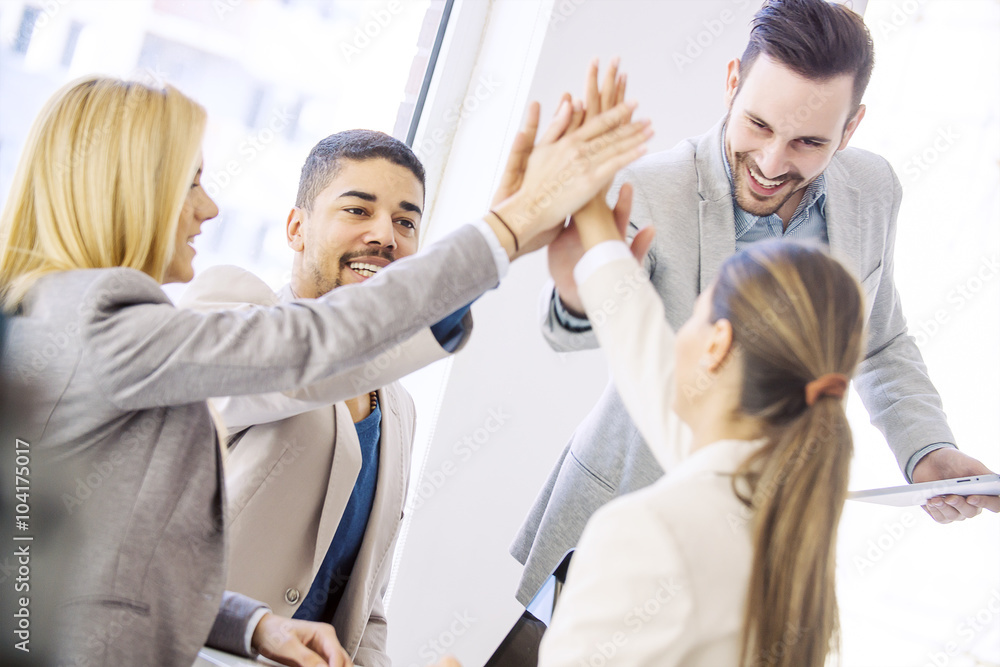Young business people joining hands together for success Young business people joining hands together for success
