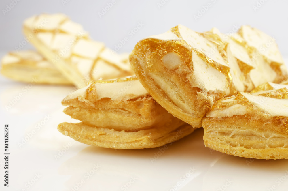 Confectionery theme. Puff a cookies, topped with honey on a bright surface. Confectionery theme. Puff a cookies, topped with honey on a bright surface.
