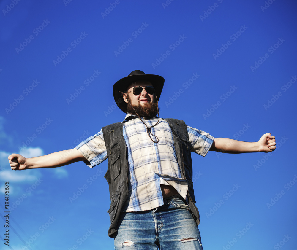 Naklejka premium Farmer in the hat and sunglasses with the pitchfork outdoor
