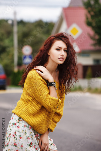 High fashion stylish hipster girl in the yellow sweater outdoor