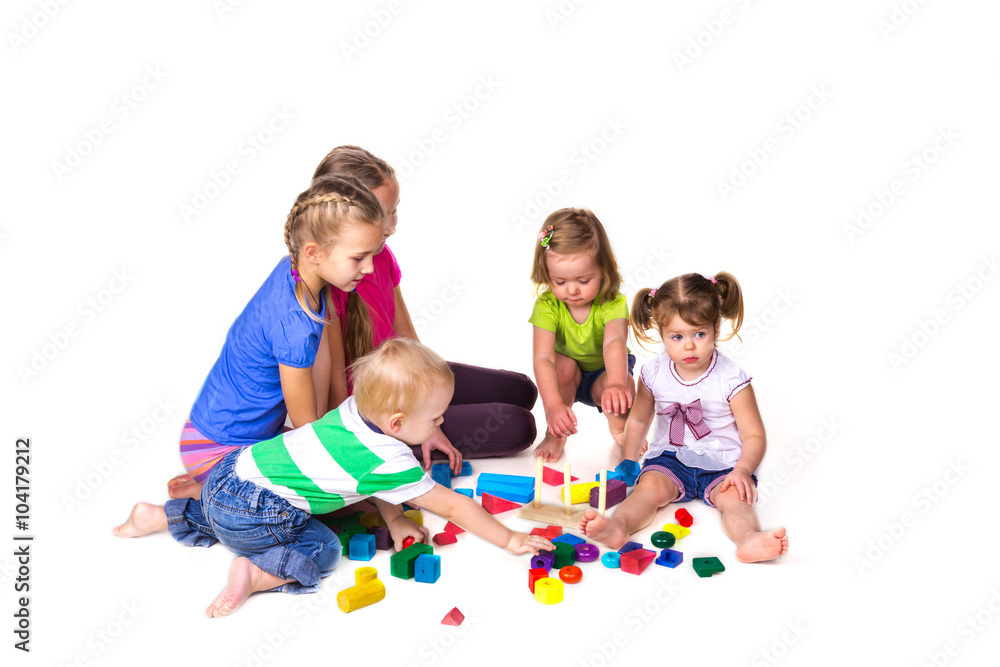 Happy kids playing with building blocks isolated on white Happy kids playing with building blocks isolated on white