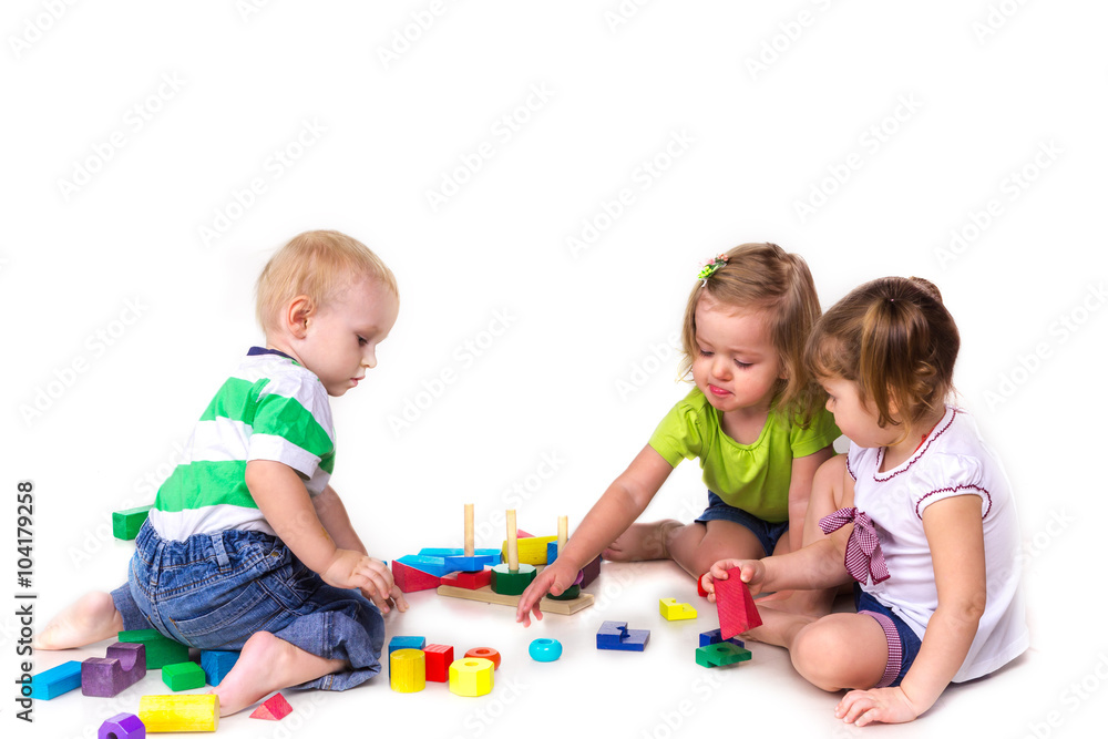 Happy kids playing with building blocks isolated on white Happy kids playing with building blocks isolated on white