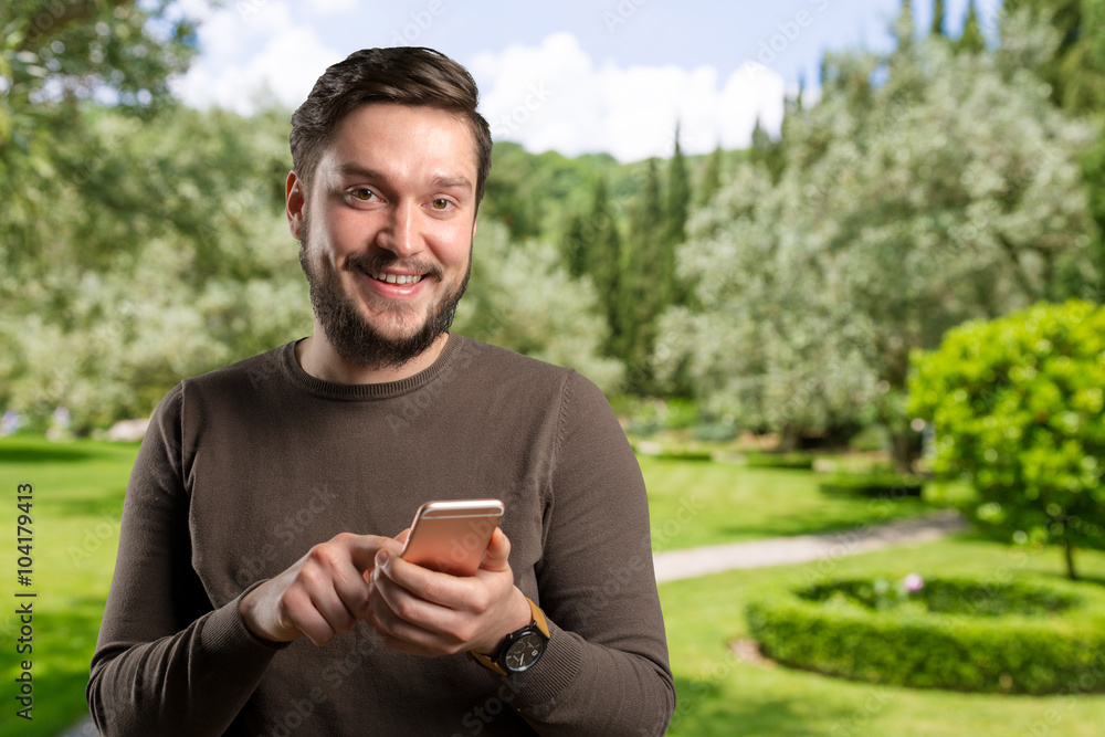 Handsome young man using his smartphone Handsome young man using his smartphone