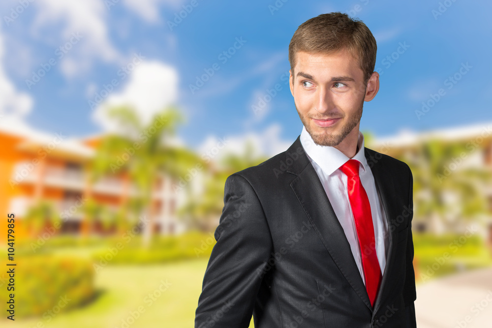 Young Businessman looking over his shoulder Young Businessman looking over his shoulder