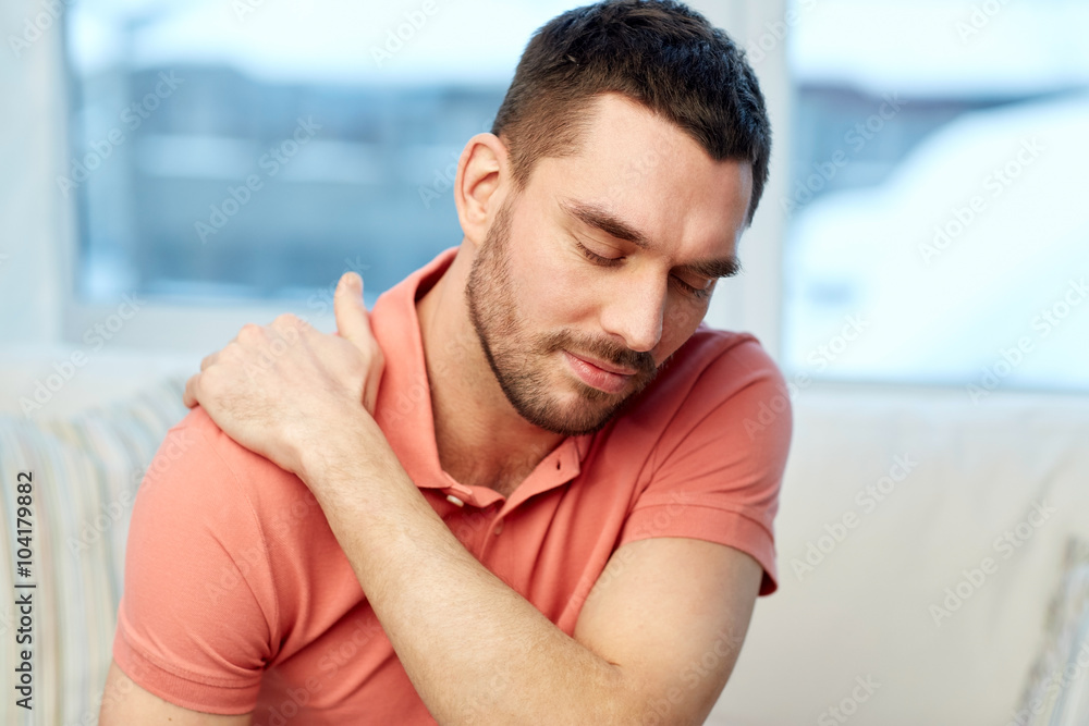 Fototapeta premium unhappy man suffering from neck pain at home