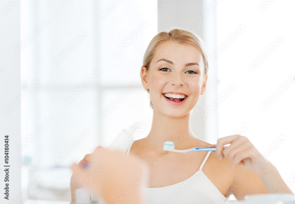 woman with toothbrush cleaning teeth at bathroom woman with toothbrush cleaning teeth at bathroom