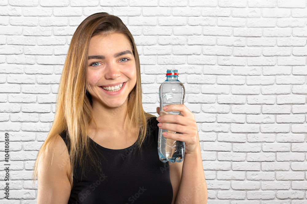 Beautiful young woman with bottle of mineral water Beautiful young woman with bottle of mineral water