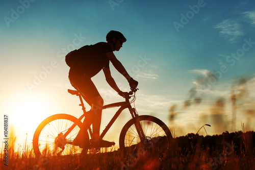 Rider on Mountain Bicycle it the field