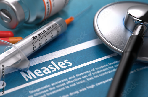 Measles - Medical Concept with Blurred Text, Stethoscope, Pills and Syringe on Blue Background. Selective Focus. 3D Render. photo