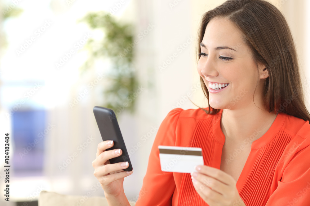 Lady buying with credit card and smart phone Lady buying with credit card and smart phone