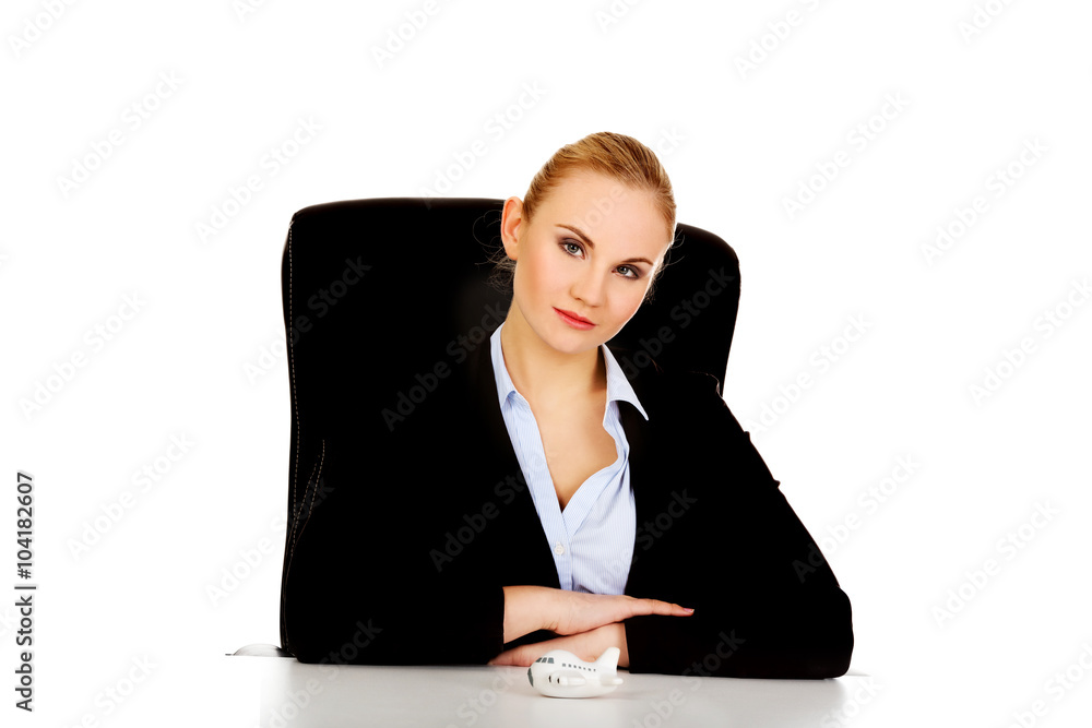 Business woman with airplane toy on the desk Business woman with airplane toy on the desk