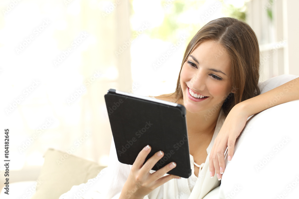 Fototapeta premium Woman reading ebook at home