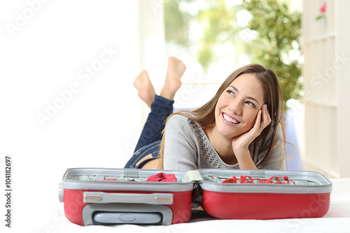 Woman thinking and preparing a travel photo