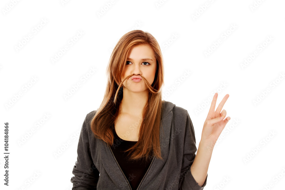 Funny teen woman putting hair like mustache Funny teen woman putting hair like mustache