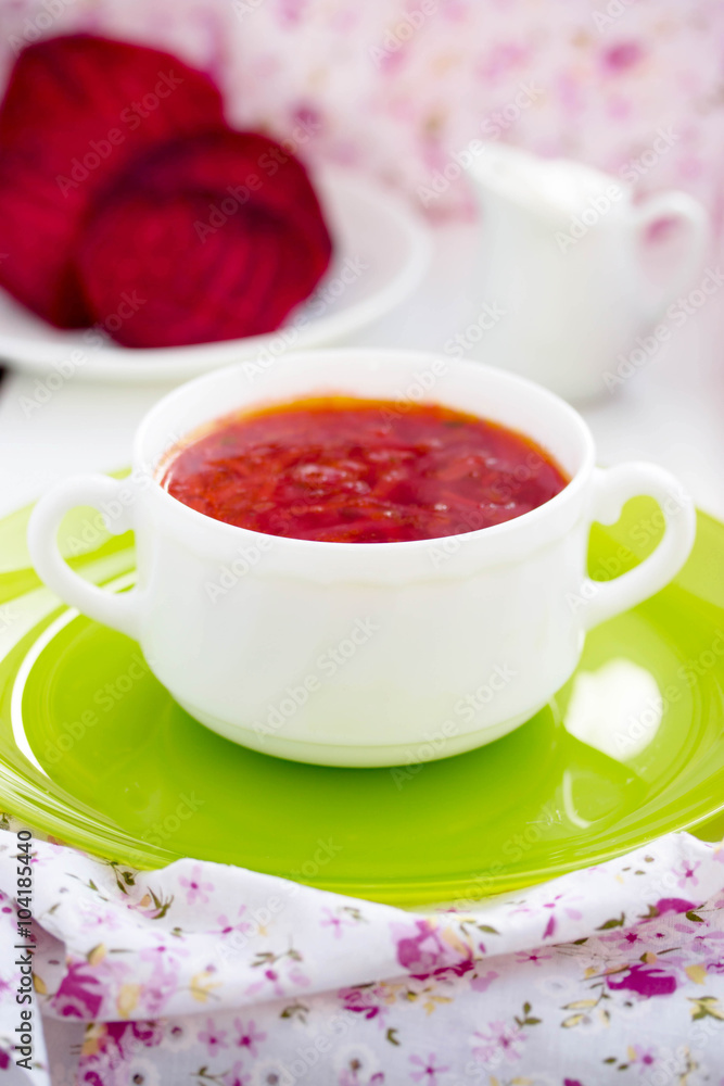 Red Ukrainian borsch soup with sour cream in a white plate. Red Ukrainian borsch soup with sour cream in a white plate.
