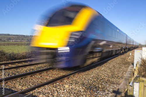 Close up of train speeding through English countryside with motion blur