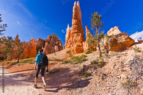 woman exploring trails in bryce canyon landscape