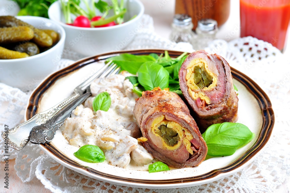 Roulade of beef stuffed with bacon, scrambled eggs, pickled cucumbers garnished with mushrooms stewed in sour cream.