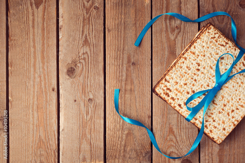 Matzoh for jewish holiday Passover (pesah) on wooden background. View from above photo