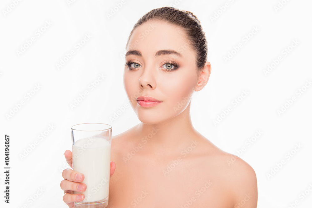 Portrait of attrective young woman holding glass of milk coktail