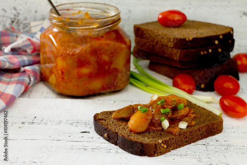 Home caviar of tomatoes and beans, spread on bread, in a rustic