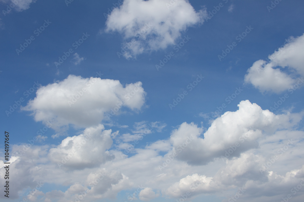White puffy clouds on the background blue sky White puffy clouds on the background blue sky