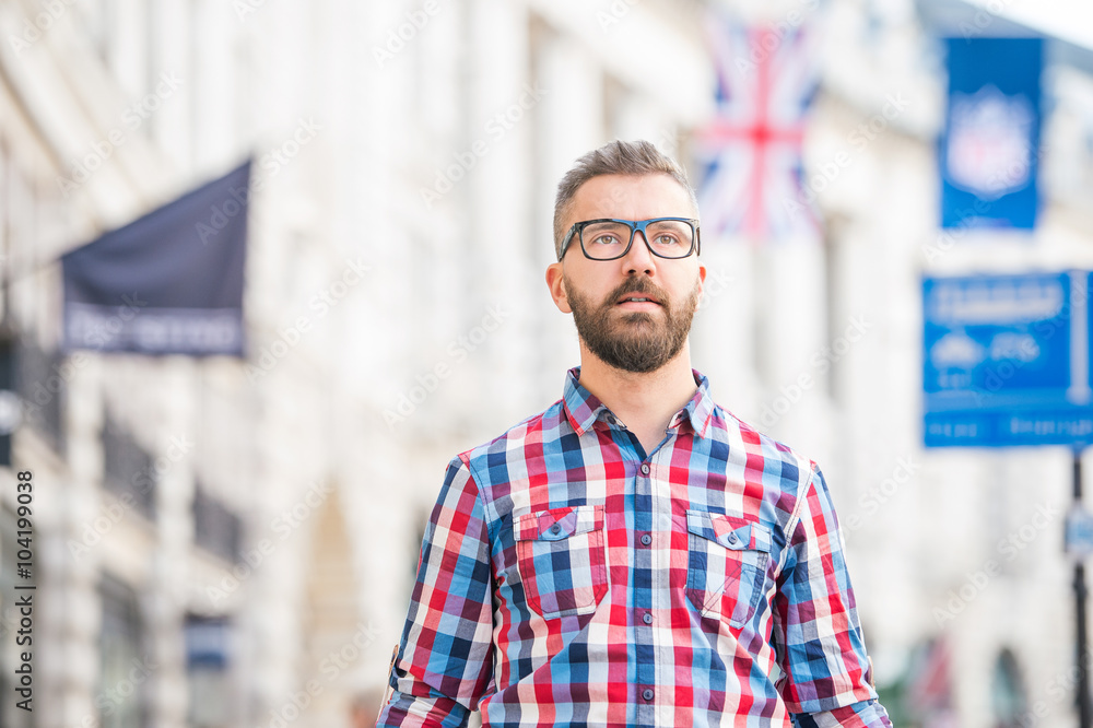 Hipster man with eyeglasses shopping in streets of London Hipster man with eyeglasses shopping in streets of London
