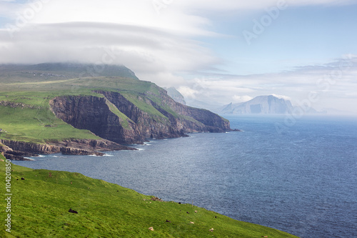 Mykines island and Atlantic ocean in Faroe islands in summer. photo
