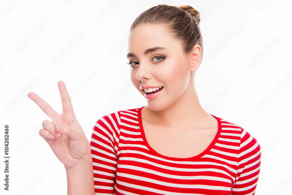 Cheerful creative girl gesturing with two fingers Cheerful creative girl gesturing with two fingers