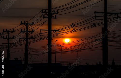 Silhouette of Street lights in sunset sky