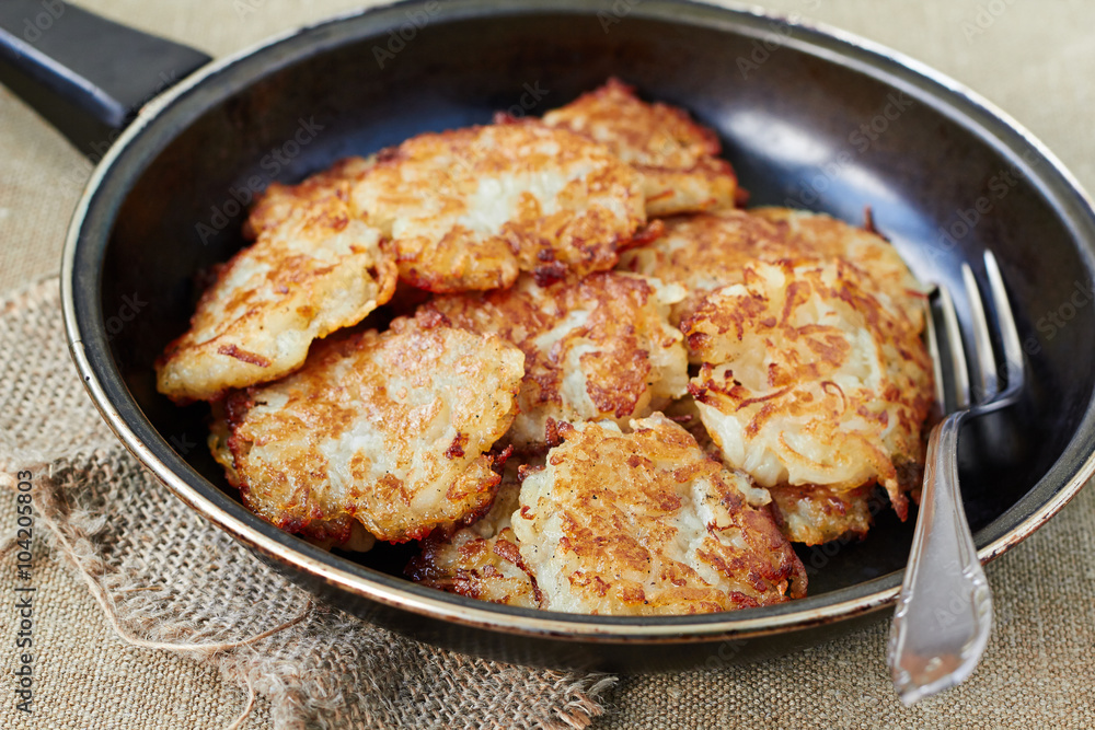 Homemade traditional potato pancakes or latke Hanukkah celebration food in pan Homemade traditional potato pancakes or latke Hanukkah celebration food in pan
