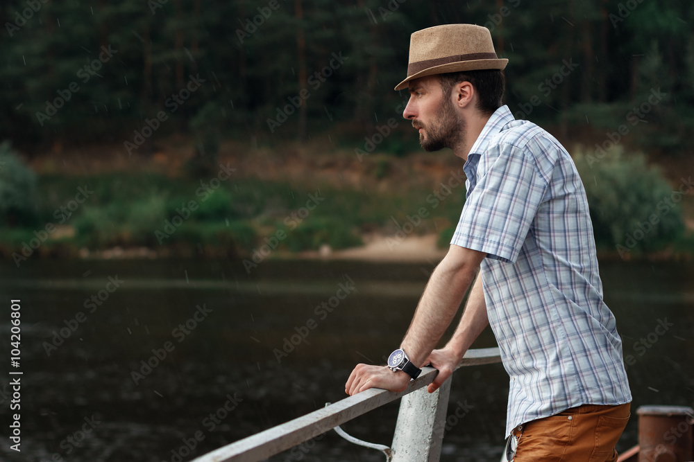 man with beard in hat near the river man with beard in hat near the river