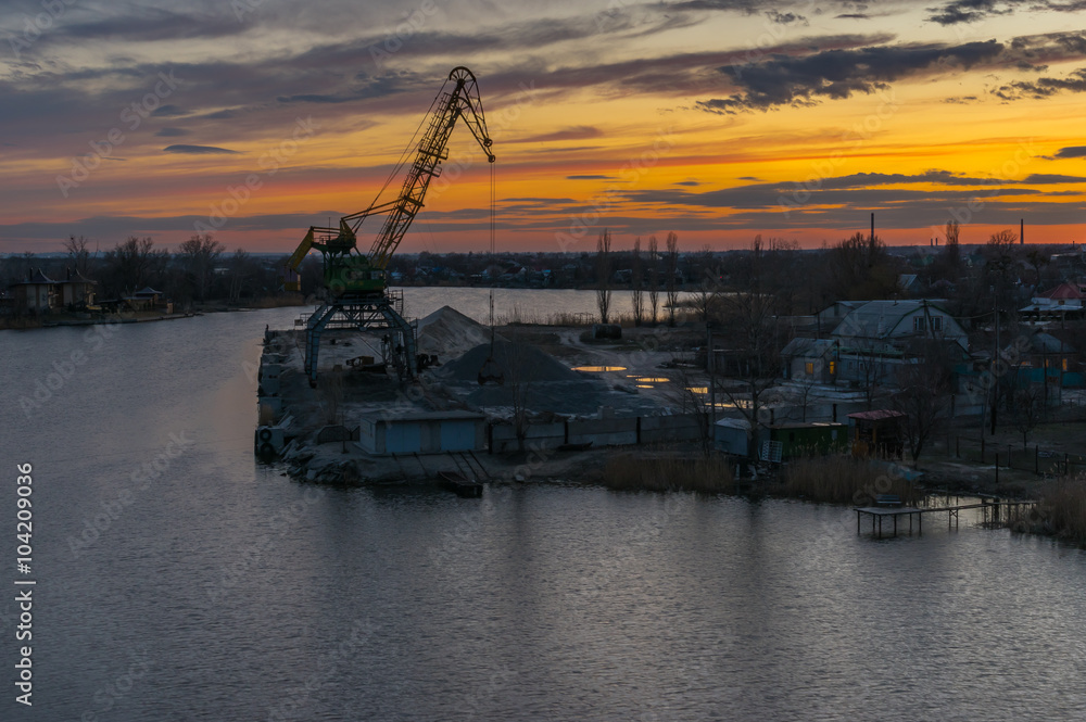 Fototapeta premium Evening landscape with small cargo port on Samara river in Novomoskovsk city, Ukraine