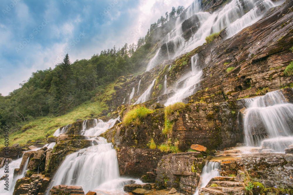 Fototapeta premium Famous Tvindefossen Waterfall in Norway. Amazing and beautiful v