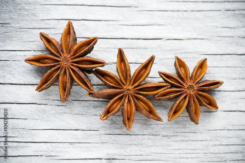 Spices. Anise stars on the vintage wooden background 