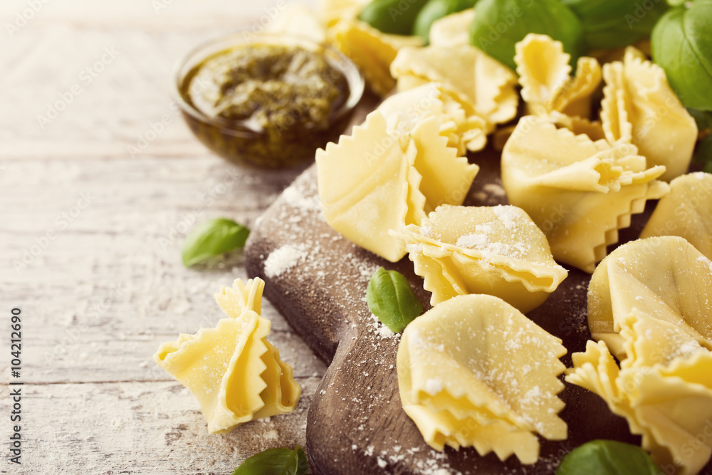 Homemade raw Italian saccottini with green pesto Homemade raw Italian saccottini with green pesto