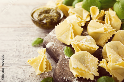 Homemade raw Italian saccottini with green pesto photo